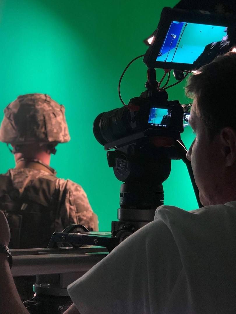 Camera on a slider filming a soldier against a green screen